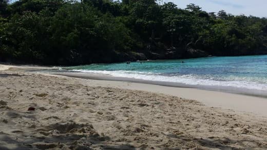This photo of one of Ocho Rios's beach with a mass of greenery in the background is a perfect example of why Ocho Rios' rugged beauty is the perfect resort town for those seeking natural beauty while having access to some of Jamaica's best activities
