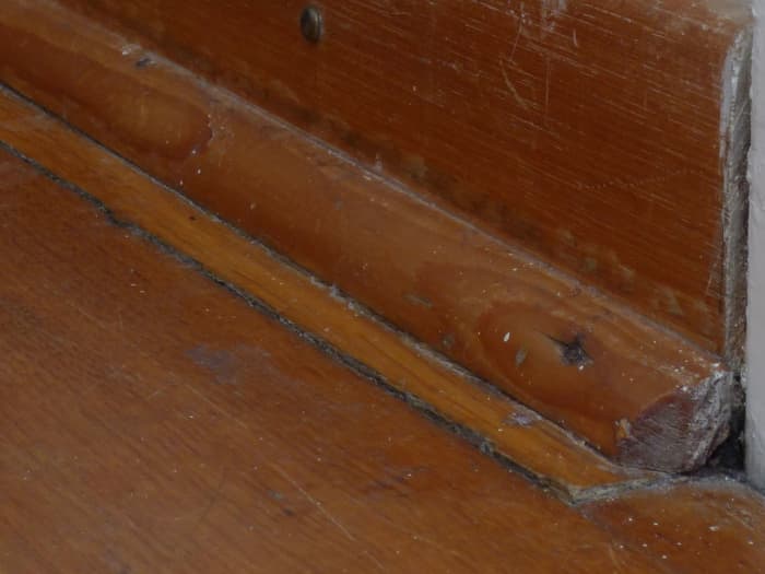 See that strip that covers the gap between the baseboard and the floor? That's what we call quarter round trim. Sometimes it's painted, but sometimes (as in this photo) it's not.