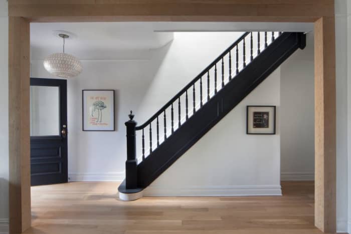 The interpretation that there is the a landing between the bottom riser of a set of steps and a door. In other words one should not be forced to come down a set of steps and for a door knob while standing on the last tread.