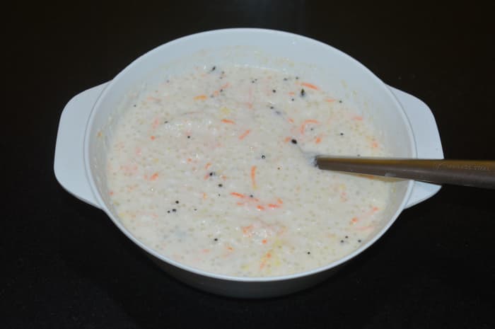 Step three: Add fruit salt or baking soda. Pour a tablespoon of water over it. When bubbles form on it, mix the batter gently. Now, the batter is ready for making idlis.