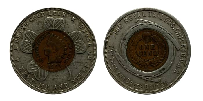 1901 encased Indian Head cent. Obverse features a four-leaf clover, and the legend reads, “I BRING GOOD LUCK/KEEP ME AND NEVER GO BROKE.” The reverse legend reads “THE ROYAL TAILORS, CHICAGO, U.S.A./PAY LESS AND DRESS BETTER.”