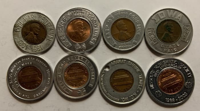 Eight different typical encased cents in circular holders. The four top examples show the obverses, while the four bottom examples show reverses. Examples like these normally sell in the $3 to $10 range.