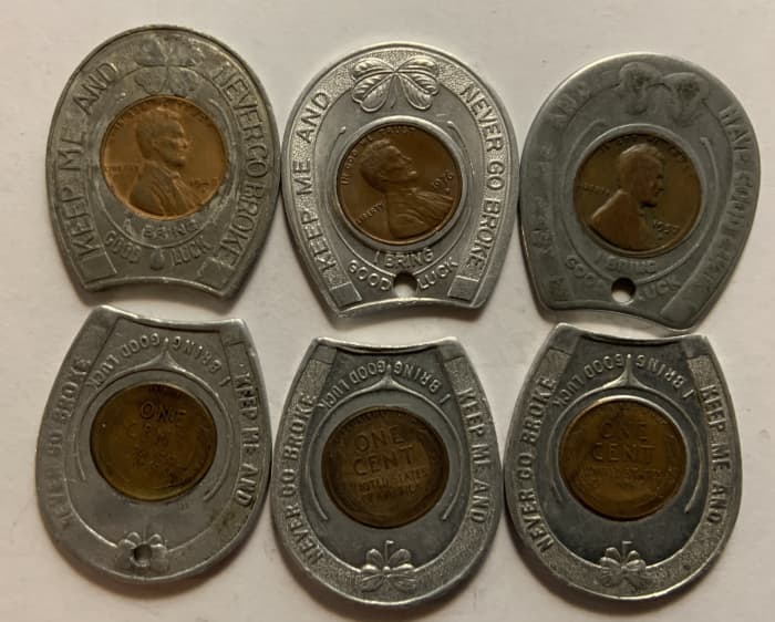 Six different typical encased cents in horseshoe shaped holders. The three top examples show the obverses, while the three bottom examples show reverses. Examples like these normally sell in the $5 to $10 range.