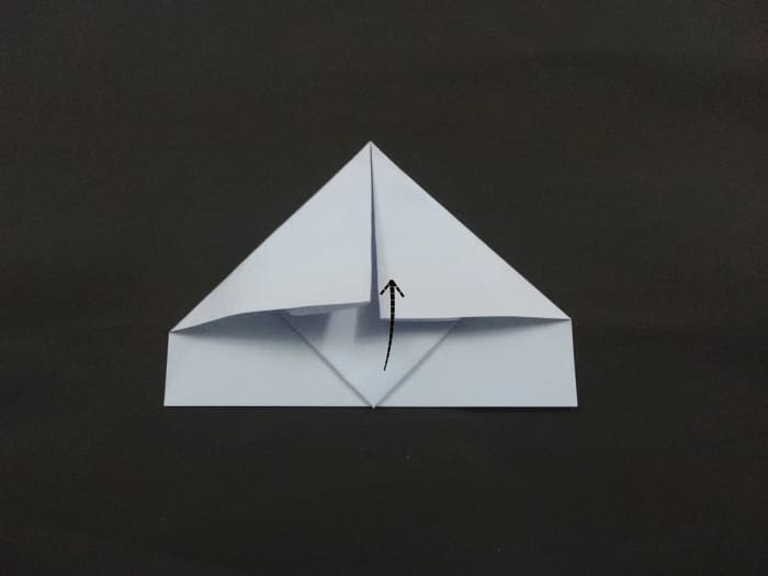 The head of the triangle visible below the folded corners. You need to pull the tip of head upwards as shown.