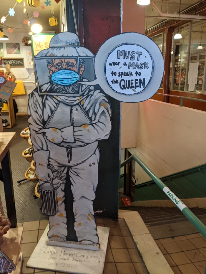 Mask notice at entrance to a shop selling honey in Seattle's historic Pike Place Market