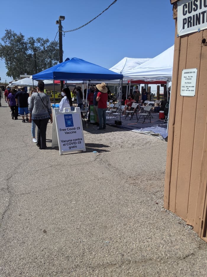 Tent at a Cinco de Mayo event in Tucson dispensing walk-in COVID immunizations