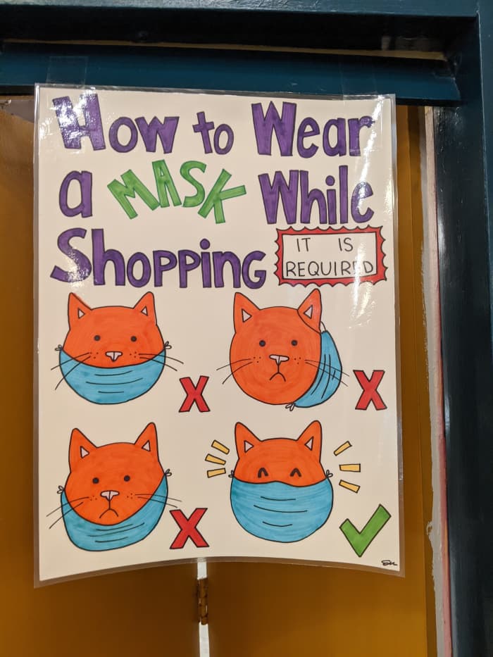 Sign in a store with instructions on how to properly wear a mask