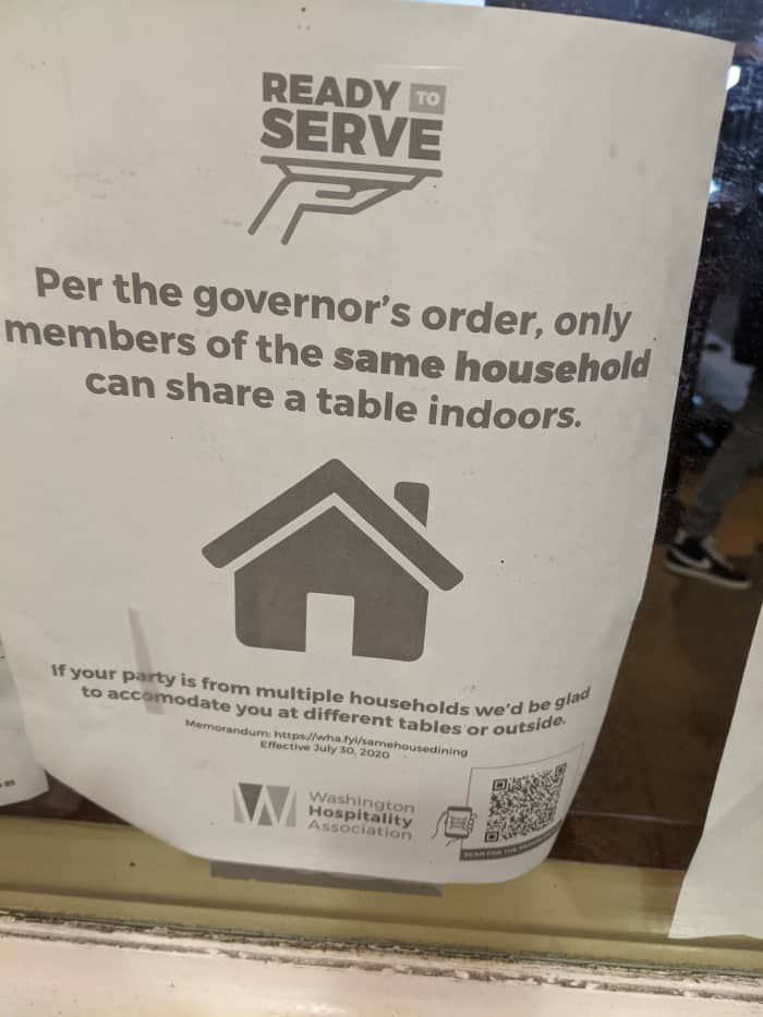 Sign in Seattle restaurant limiting seating by order of the state's Governor.
