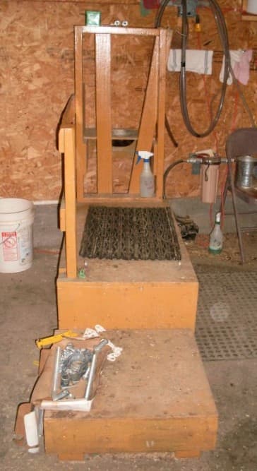 Here is the milk stand. The step was originally built for Morgana's Aunt Jingles, as she had trouble jumping up without stepping on hers own teats. Several of the goats continue to appreciate this arrangement.