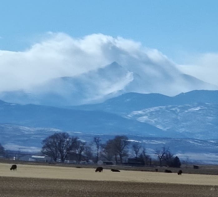 The stormy face of Long's Peak scowls down upon Mel as he hacks out his cold-hearted book reviews.