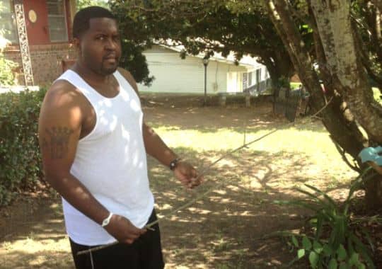 Friend of Adrian Peterson who is holding a stick from the tree where Peterson got a limb to use on his child.