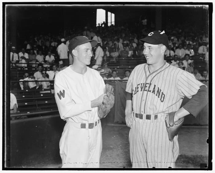 Cleveland Indians pitcher Bob Feller (right) meets with Washington Senators pitcher Bucky Jacobs prior to a 1937 matchup. The two youngsters were among the most highly touted pitchers at the time but only Feller would continue on to become a legend.