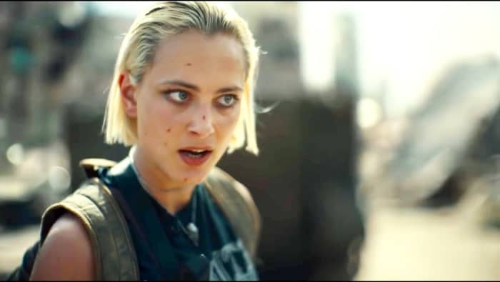 Then a girl with short hair arrives there. The girl who helped that other refugee girl to arrive here. She kills a nonsense security officer there. She says that zombies will take him and we will be safe.