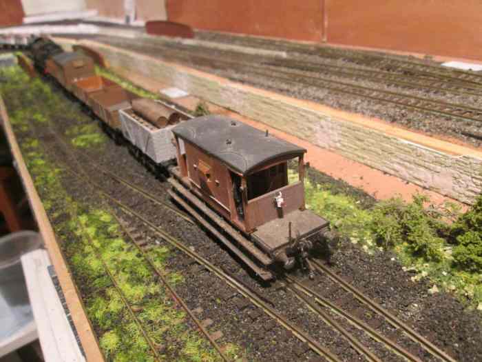 Guard's van passes the photographer on its way at the train's tail to Unit 3, with bridge side walls over underground wartime factory unit. At the back a lighter ballast mix has been fixed down and will form the basis of the main running lines