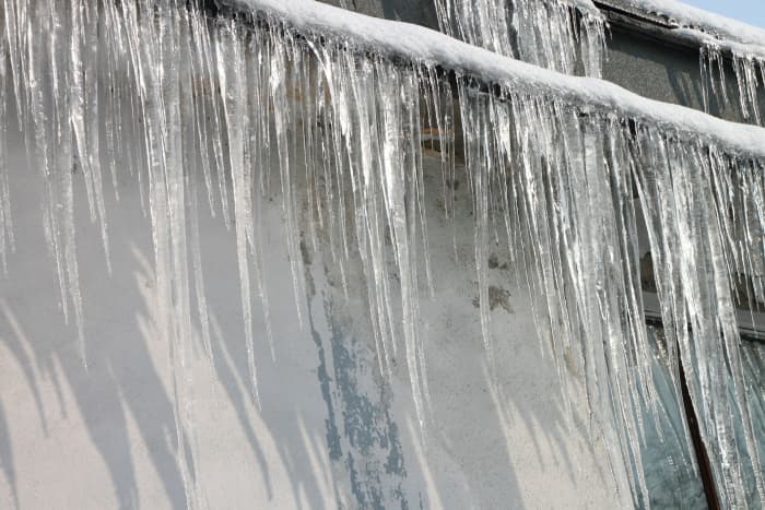 A buildup of ice around the edges of your roof can cause an ice dam, water backing up behind it and seeping through the gaps in your roof tiles.