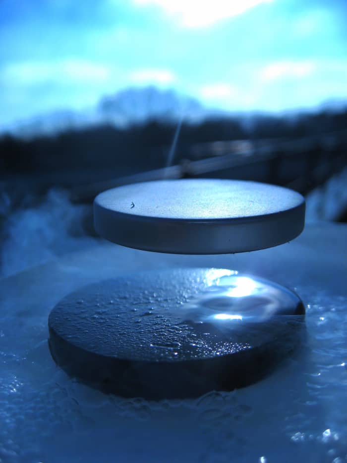 A superconductor levitating the permanent magnet.