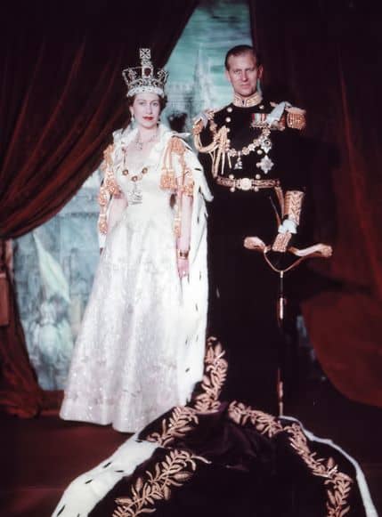 A photograph from 2nd June 1953 taken after Elizabeth II's coronation. She is shown with Prince Philip (1921-2021) and wearing the Imperial State Crown.