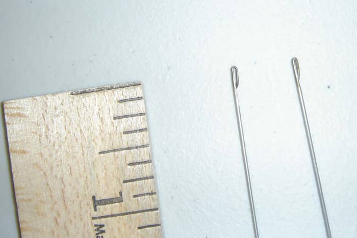 The eye part of the needle is open, to make threading the needle easier. You can make your own lei needles, if you are handy.