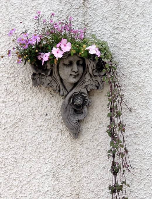 You can buy or make wall planters that are simple or complicated, depending on how creative you are. Even just buying a colorful half pot will work.