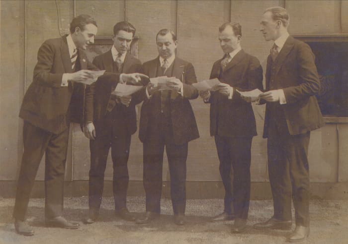 The Louisiana Five looked over their musical contracts. Some of these gents may be doing the same for their next life times, now.