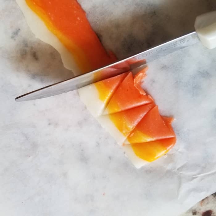 If you cut the candy corn in alternate directions, the ends will be different colors based on which direction they were cut. Note some pieces are orange on the bottom, and some are white in this photo.