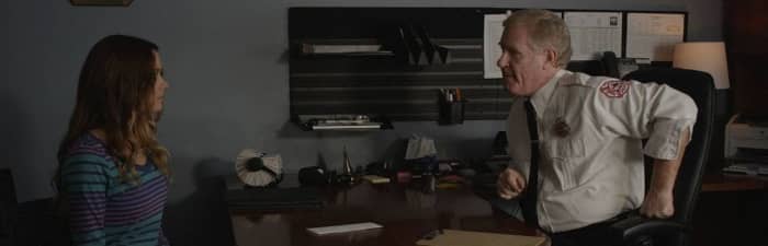 Joan Conroy (Gina Holden) submits her resignation to Chief Caldwell (Robert Pike Daniel) before learning that her daughter is trapped in a sink hole
