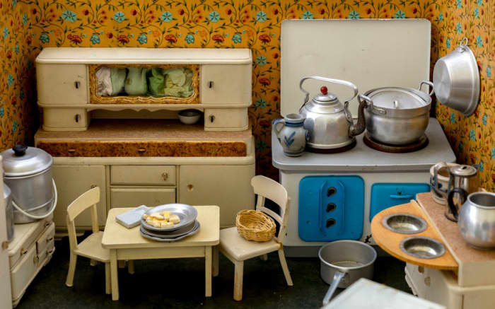 Vintage miniature home's kitchen with everything a young girl needs to practice cooking, cleaning, and organizing.