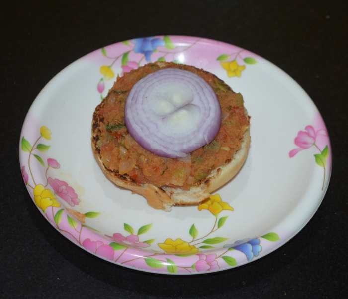 Place one or two thin onion slices on it.