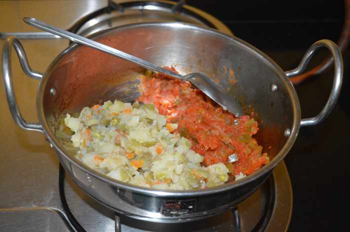 Add it to the capsicum-tomato mixture in the pan.