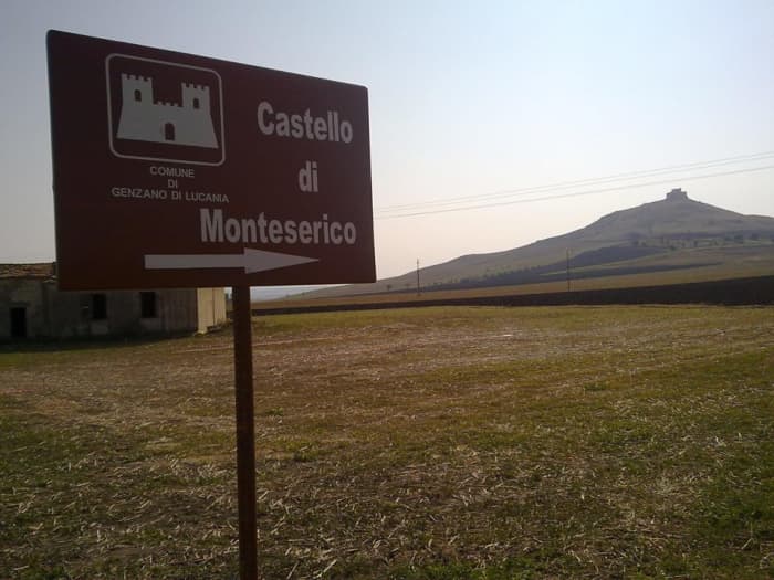 The ancient castle of Monteserico seen from far away country fields, there is also an old farm building in the picture. Note, here above is also a map to see where Genzano and this castle are