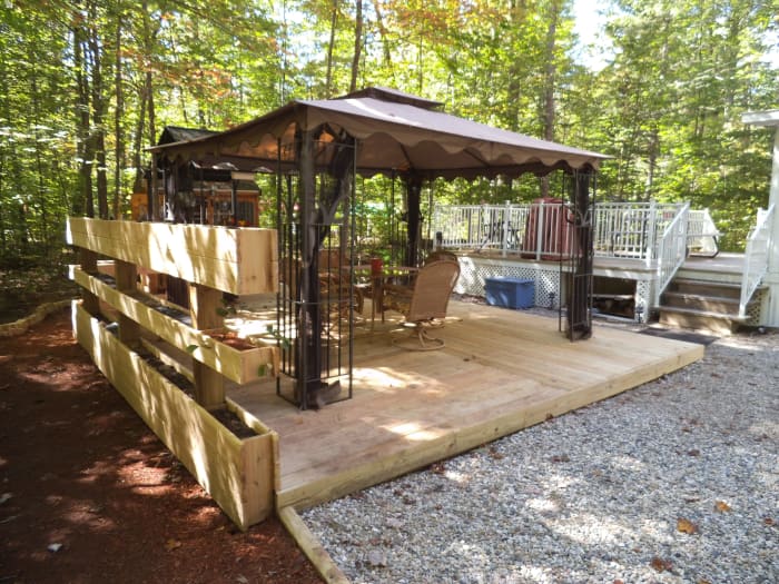 Here's where we moved the gazebo to the ground-level deck my husband constructed. On one side are raised planters for additional flowers and herbs.