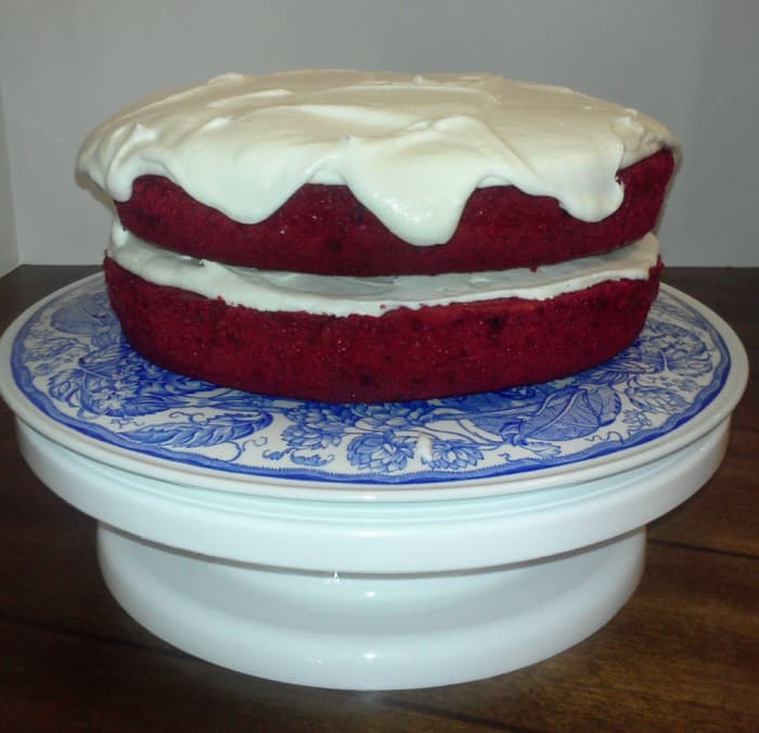 Exposed layers make for a pretty cake, but it is at risk of drying out sooner, so keep it covered. Here it is still on the lazy-susan-type decorating stand.
