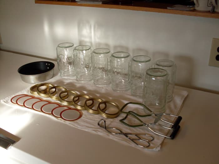 Wash smallish jars (sterilize if necessary), and examine for chips and cracks. Also rings (bent, excessive rust), and lids (misaligned rubber). Heat boiling waterbath canner, about two-thirds full of water for a full load.
