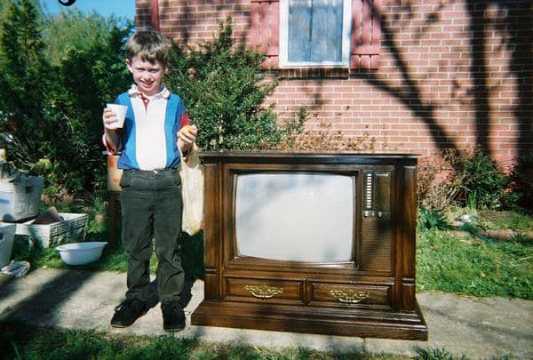 Grantley Waters standing in next to a Curtis Mathes Console. I designed the cabinet for this color console back in the early 1980s when I worked for the company.
