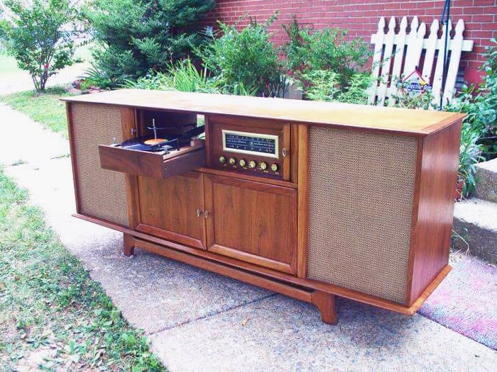 This model has a hi-fidelity AM-FM Radio and turntable It has ample storage behind the two doors and all the knobs, tuners, turntable etc. are tucked away into a drawer, keeping the design clean and streamline.