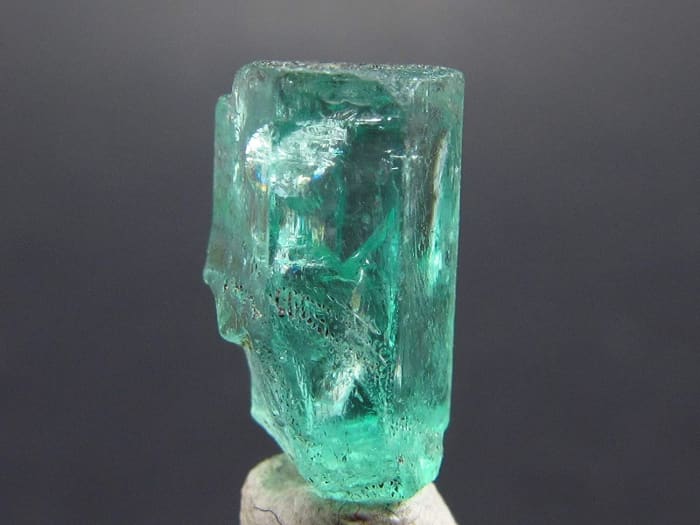 Beryl is unique in that under natural lighting, it appears a bright green color, but in artificial lighting, it can have a reddish hue.