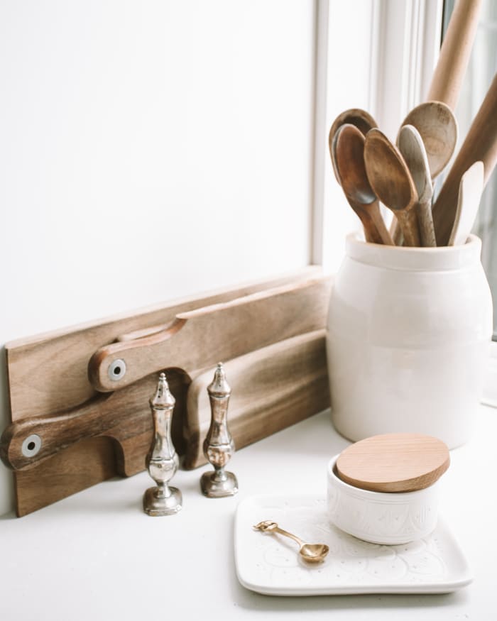 Porcelain and metal canisters are both great utensil holders.