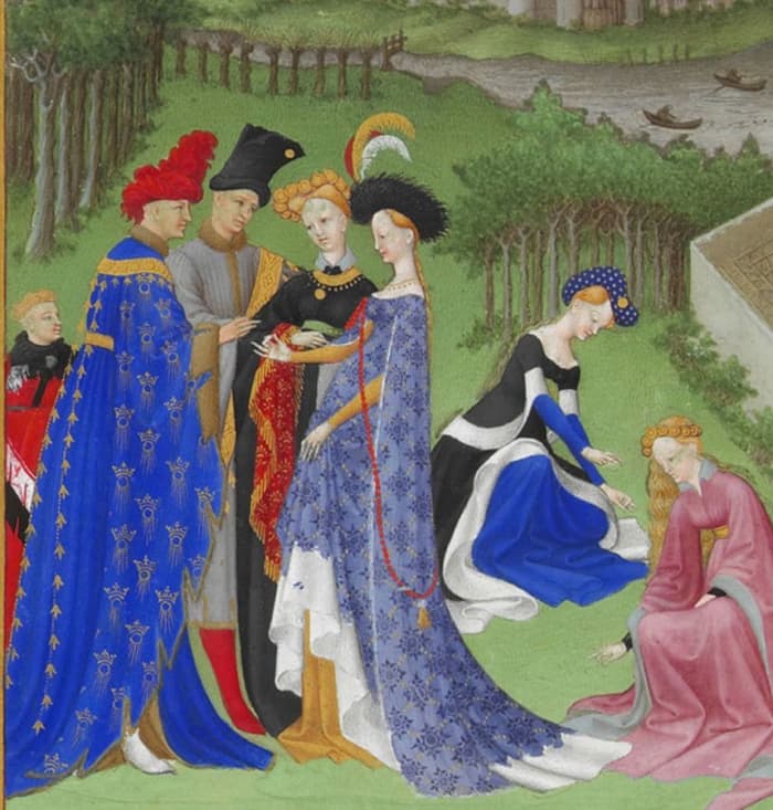 Full-bodied houppelandes with voluminous sleeves worn with elaborate headdresses are characteristic of the earlier 15th century. Detail from Très Riches Heures du Duc de Berry.