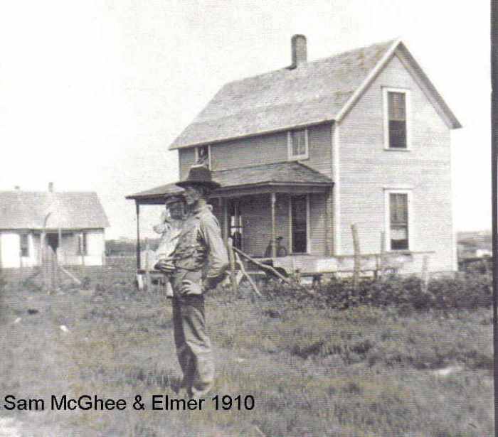 Bertha's father and brother, Sam and Elmer McGhee with their home in the background.