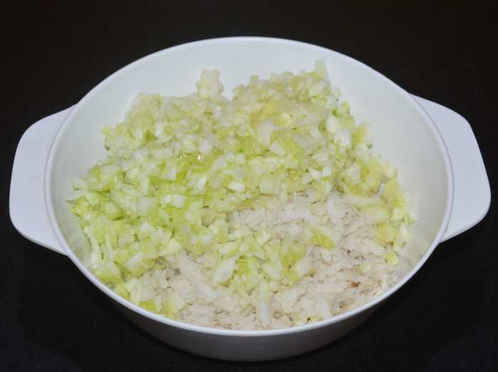 Add chopped cucumber to the bowl containing poha. 