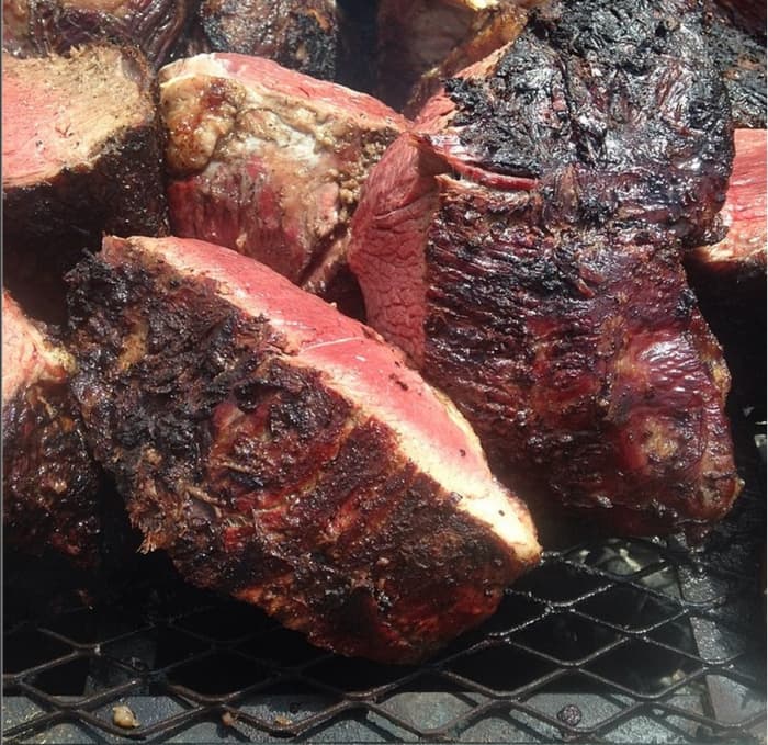 Pit beef chunks cooking on the open fire wood pit. Used with permission from Wayne Schafer, pitmaster of BIg Fat Daddy's.