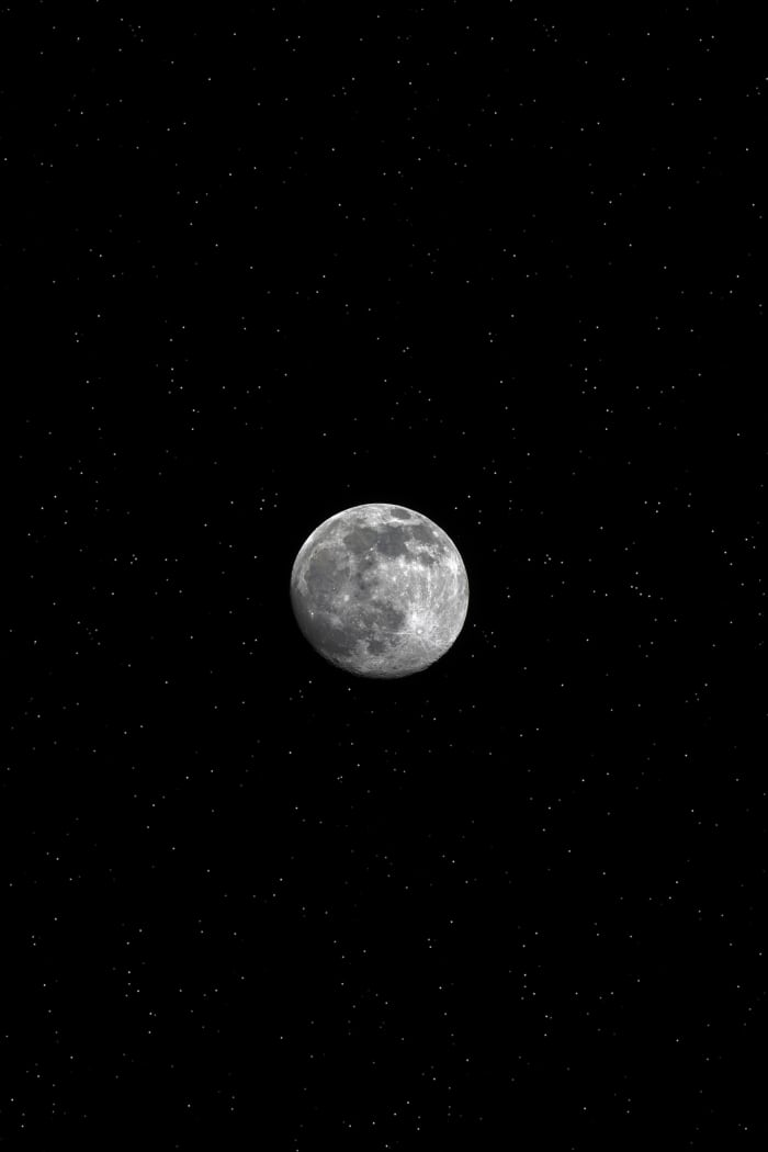The full moon in the night sky. This photo symbolizes the album's title which has to do with night time.