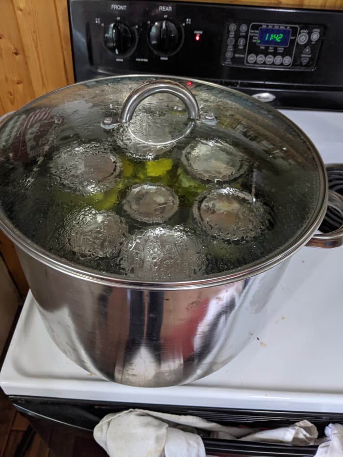 Place completed jars into boiling water bath canner. Make sure there is at least a little bit of water over the jars. Rule of thumb is inch above jars. Place lid on pan. Set timer to either 10 minutes for pints or 15 minutes for quarts.