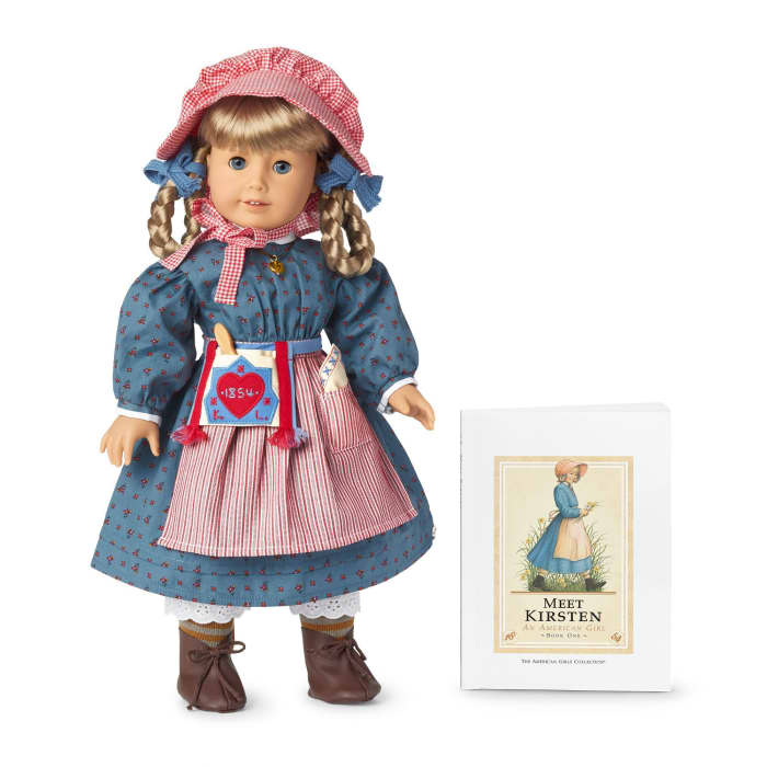 A 35th Anniversary Kirsten Doll, pictured with the Meet Kirsten book in its original design