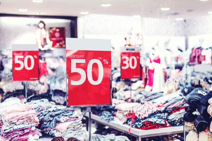 Shopping during sales is one way to get less expensive prices at brick and mortar stores. Photo by Artem Beliaikin from Pexels