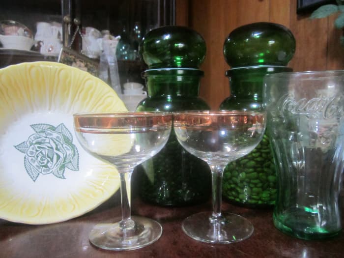 Green cannisters for beans, cool old bowl, champagne glasses, and Coke glass. Kitchen items are plentiful at yard sales.