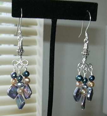 Wire wrapped .925 sterling silver and cultured freshwater pearl chandelier earrings. I handcrafted all the jewelry wire in this pair, including the ear-wires.