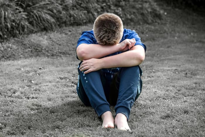 This photo symbolizes what is on the cover of the album The Great Cold Distance and the person depicted is a despondent person.