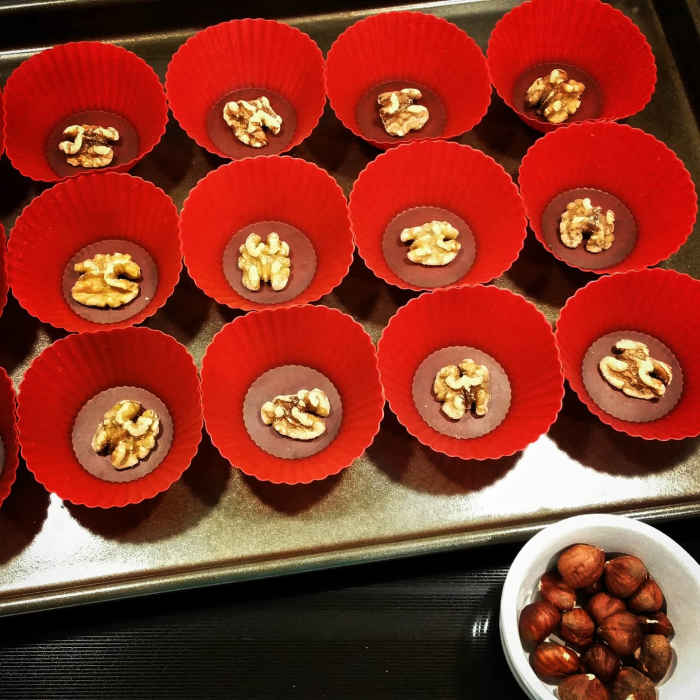 Set a half walnut into the bottom of each silicone baking cup.
