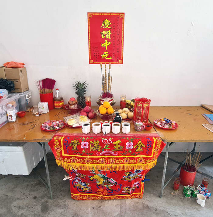 A community altar during the Ghost Festival. The poster above the altar says “celebrating Zhongyuan”